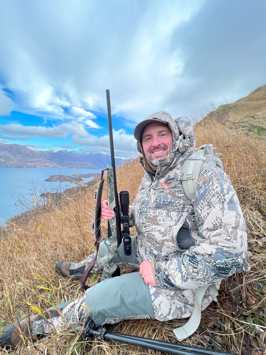 Skip Knowles on a mountain holding a Lupo Rifle