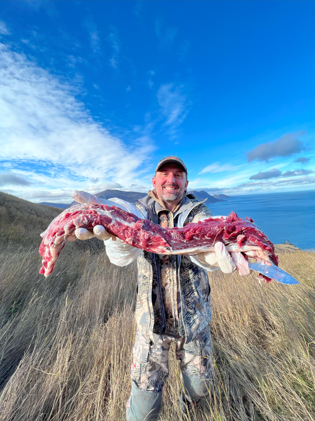 Skipp holding up deer meat 