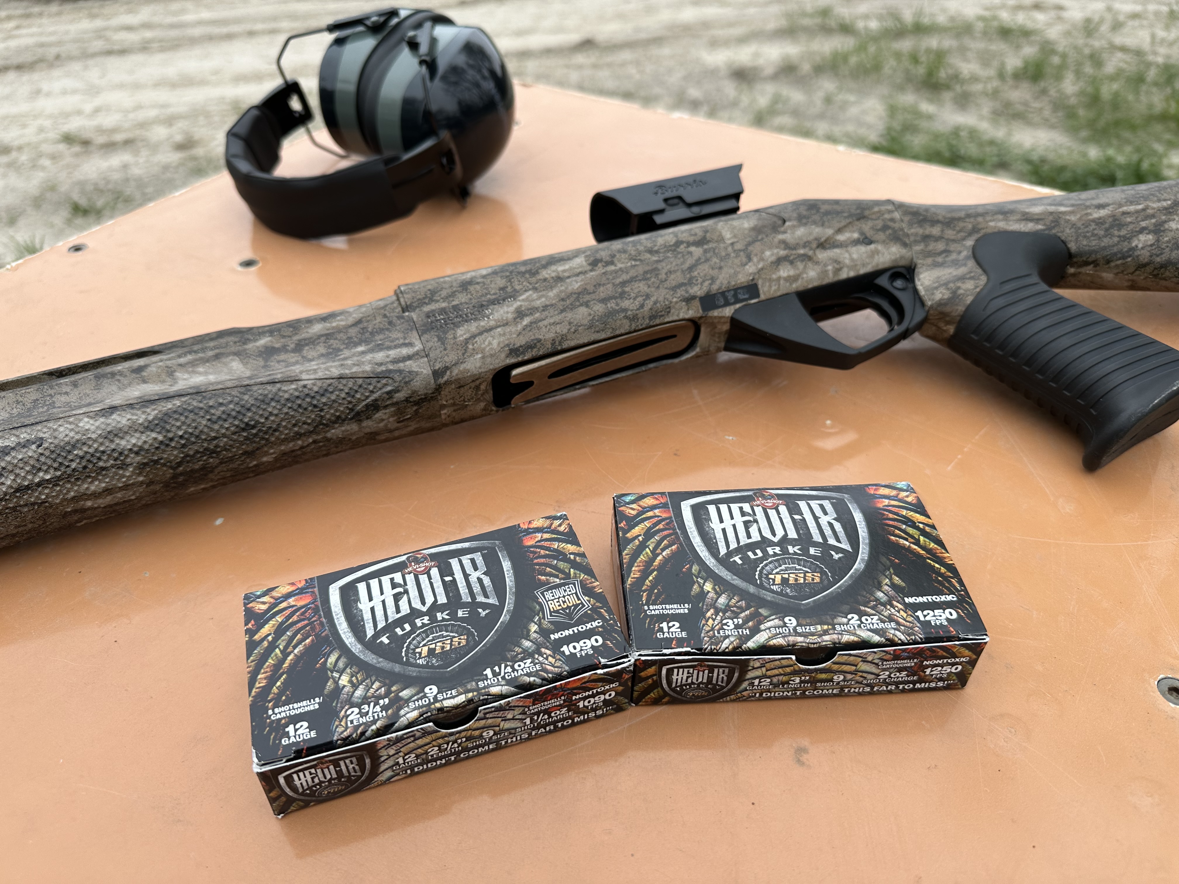 Benelli Turkey shotgun and hevi shot TSS on a table with ear muffs