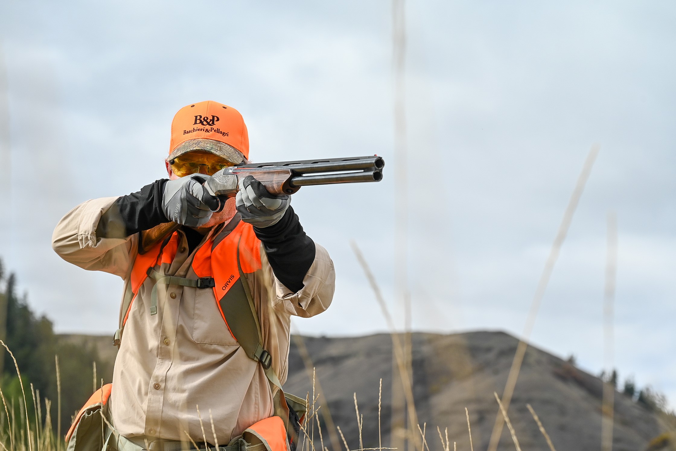Scott pointing and shouldering an 828 U in the pheasant field 