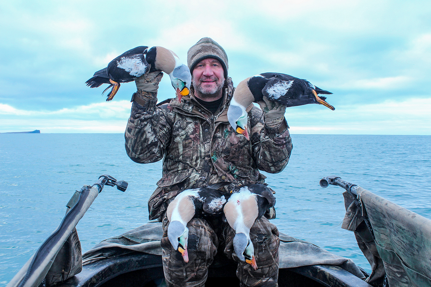 Scott with two KingEider Ducks in a boat in AK