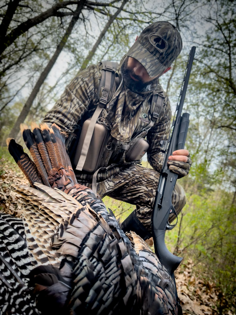 Hunter with harvested Turkey and Benelli M2 shotgun 