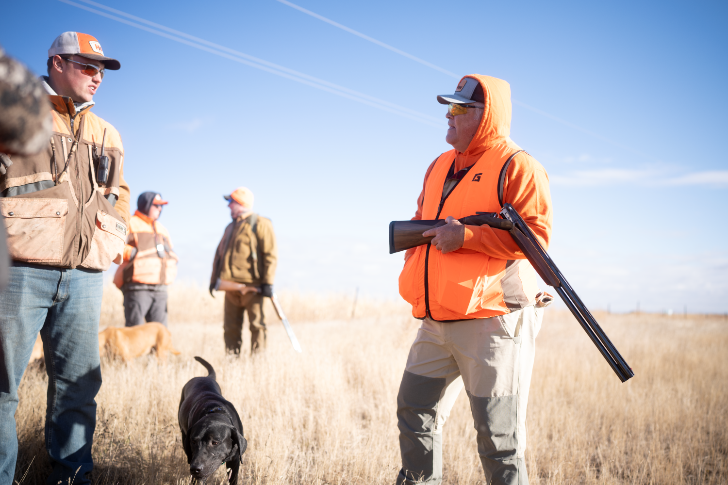 Guide for the hunt talking to doug in the Pheasant field with dog