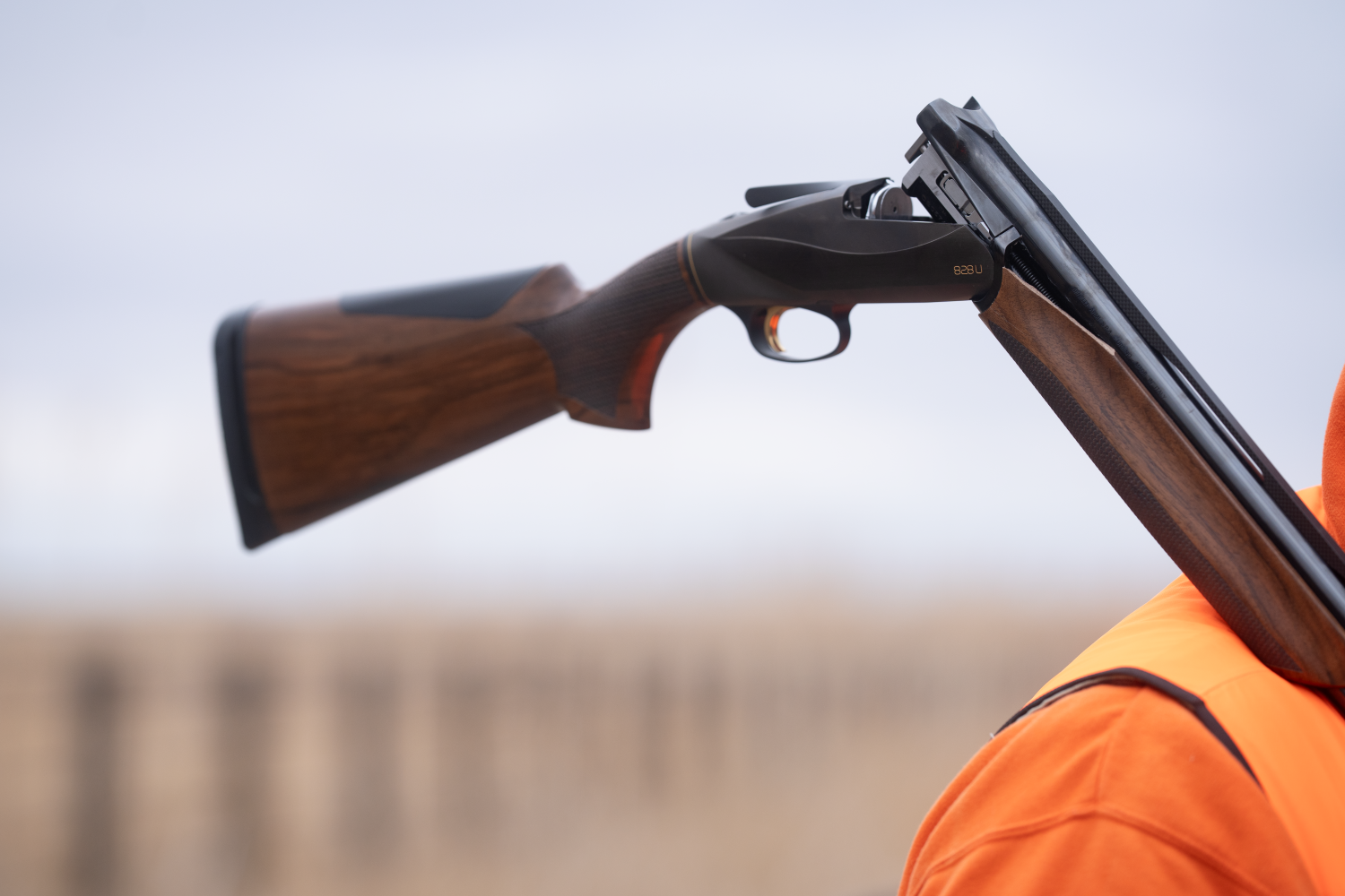 Benelli 828 U broken open on a hunters shoulder 