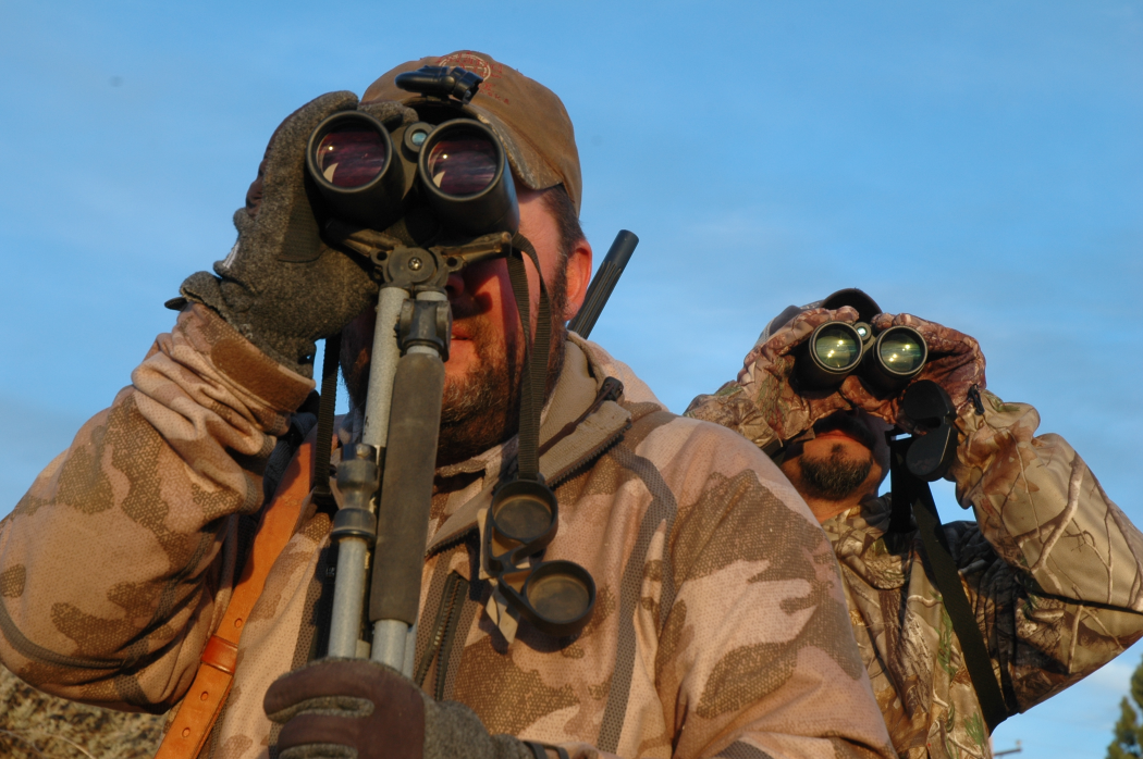 Hunters scouting a buck with binoculars