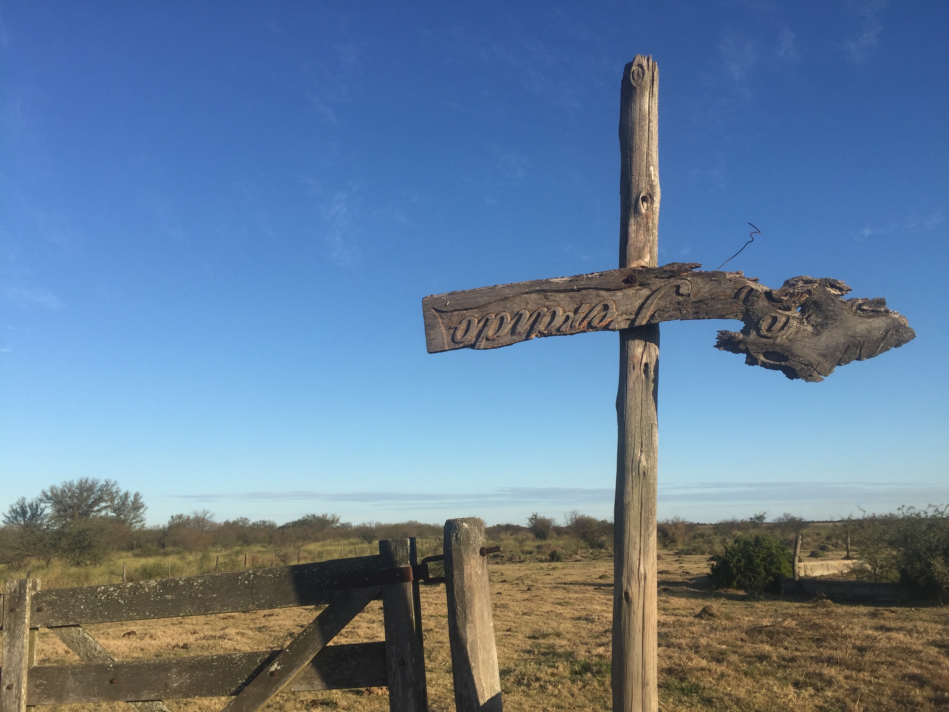wooden post with an upside down sign that is old 