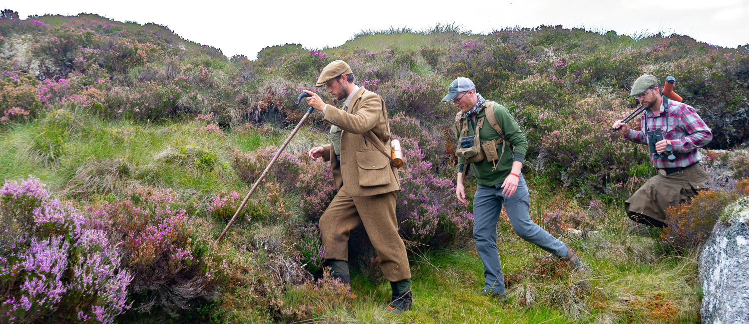 Hunters hiking in Heather and moss 