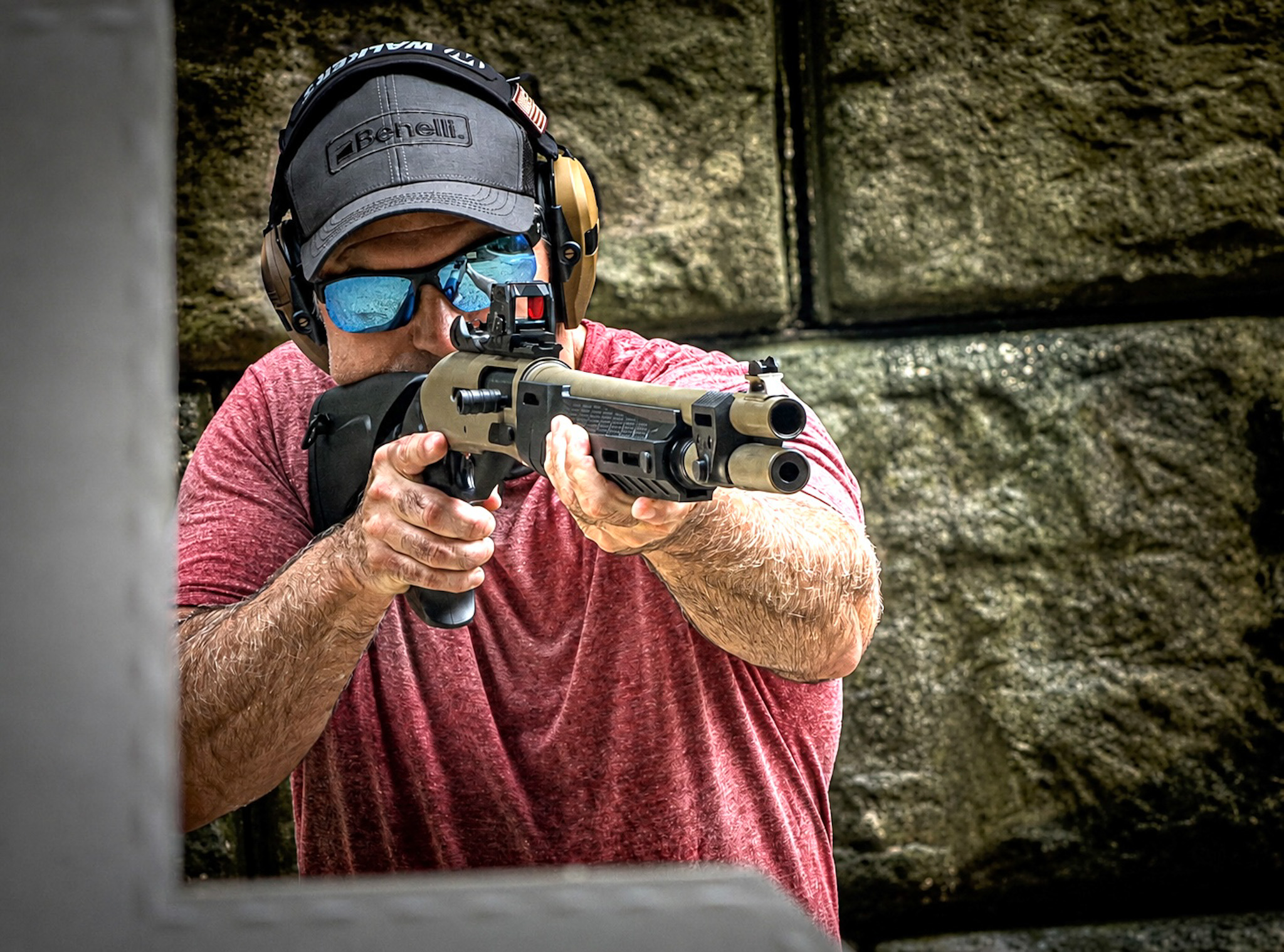 Man aiming the M2-G1 behind concrete half wall